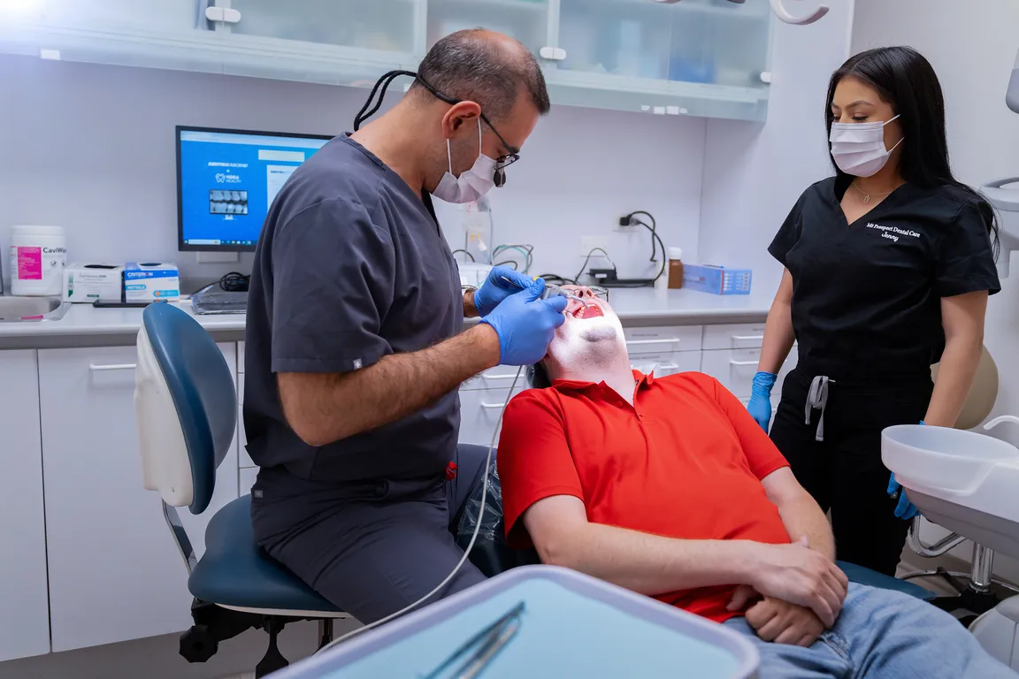 The dental team providing chairside treatment in Mount Prospect, IL