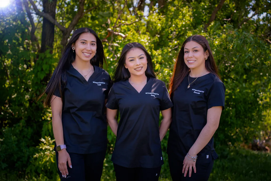Three Mount Prospect Dental Care team members outside the dental office