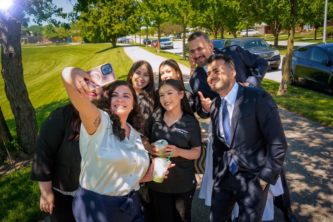 The Mount Prospect Dental Care team taking a group photo outside the practice